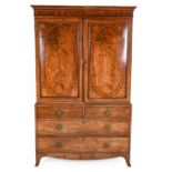 A George III Mahogany Linen Press, circa 1800, the moulded cornice above cupboard doors with oval