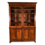 ^ A Late George III Mahogany Bookcase Cabinet, early 19th century, the Greek Key dentil cornice