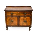 A Regency Style Mahogany Harlequin Desk, the hinged lid enclosing a green baize-lined writing