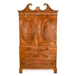 A George III Mahogany Linen Press, late 18th century, the scrolled pediment above an arcaded