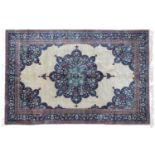 Indian Carpet, 2nd half 20th centuryThe plain cream field with indigo flowerhead medallion framed by