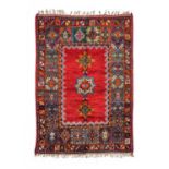 Moroccan Berber Rug, circa 1960The crimson field with three linked medallions framed by