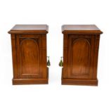 A Pair of Victorian Mahogany Pedestals, the moulded tops above arched cupboard doors enclosing