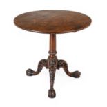 A George II-Style Carved Mahogany Tripod Table, the circular flip-top with later bearers and block