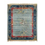 Chinese Carpet, circa 1910The ice blue field with semi-naturalistic floral sprays enclosed by deep