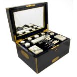 A Victorian Brass-Bound Ebonised Case Travelling Dressing Table Set, by F West, the silver