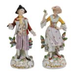 A pair of 20th century Sitzendorf figures, the lady in a yellow jacket, both on circular floral