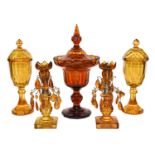 A pair of 19th century Bohemian amber glass castelettes, a similar large pedestal bowl and cover,