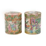 Two similar Cantonese porcelain cylindrical jars and covers, 19th century, painted with panels of