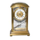A brass striking mantle clock circa 1900, the case with bevelled glass panels, Roman numeral