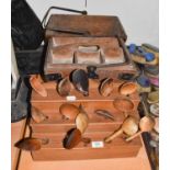 ~A 19th century pine spoon rack of three stepped form, and a collection of wooden spoons, together