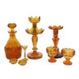 A tray of assorted 19th century and later amber glassware, including a mallet formed decanter, a