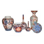 ~ A collection of Japanese Imari porcelain, including two chargers, two bottle vases, a small fluted