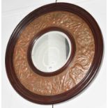 ~An Arts & Crafts circular wall mirror, with repousse copper frame, 60cm diameterCondition report: