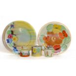 Three Clarice Cliff preserve jars and two Clarice Cliff plates, Pansies and Nasturtium patterns,