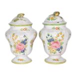 Two 20th century Continentla Faience jars and covers, each with fruit formed finials, edged in green