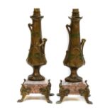 A pair of secessionist gilt metal lamp bases raised on marble plinths, 34cm high (2)Condition