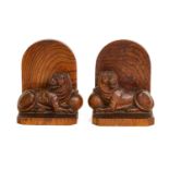 A pair of carved hardwood bookends each surmounted with a recumbent lion (2)