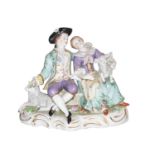 A 20th century Sitzendorf figure of a courting couple with two lambs