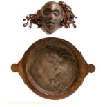 An early 19th century dough/kitchen bowl with twin-handles, together with a tribal mask