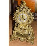 A 19th century French gilt metal striking mantel clock of Neo-Rococo form, with enamel Roman numeral