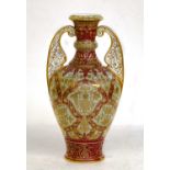 A Royal Crown Derby vase with flat scrolling pierced handles, claret ground and decorated in gilt