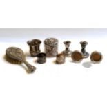 A quantity of silver items, including a pair of dwarf candlesticks, a small beaker brush and