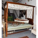 A 19th century four poster single bed with ribbon carved uprights, 107cm by 223cm by 208cm Condition
