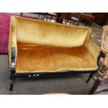 A Regency ebonised parcel gilt sofa, with leaf carved down scrolled arms and turned legs moving on