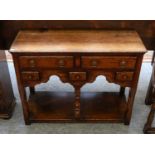 A Titchmarsh & Goodwin oak dresser base of small proportions, fitted with an arrangement of
