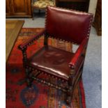 A set of six Titchmarsh & Goodwin oak studded red leather dining chairs, including two carvers (6)