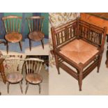 An early 20th century oak Arts & Crafts corner chair with rush seat, a set of four 19th century