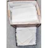 Assorted white table linen including cloths and napkins, embroidered linens, hand towels, crochet