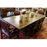 A Titchmarsh & Goodwin draw leaf refectory table, raised and turned on block legs joined by a