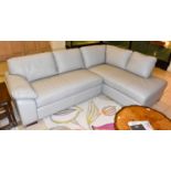A modern grey leather upholstered corner sofa, 250cm by 180cm by 90cm, together with a matching