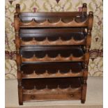 A Titchmarsh & Goodwin oak wine rack with space for twenty-five bottles and fitted with a base