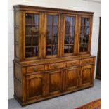 A large 20th century glazed oak bookcase/cabinet in the manner of Titchmarsh & Goodwin, the upper