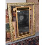 A gilt framed mirror mounted with rams heads, and a 19th century plate housed within an open