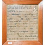 A framed woolwork sampler of two houses flanking a central tree and verse above, worked by Sarah