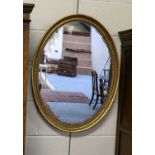 Two similar oval gilt framed wall mirrors, 56cm by 77cm (2)