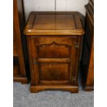 A Titchmarsh & Goodwin oak entertainment cabinet with lift up top and carved panel door, 53cm by