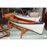 A large blue and white painted model rowing boat, 120cm long, together with a large model of a
