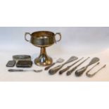 A silver two-handled cup; a pair of sugar tongs; a vesta case; a cigarette box; and a collection