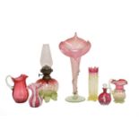 A quantity of Victorian cranberry and vaseline glass items, including an oil lamp, Jack in the