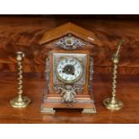 A gilt metal mounted oak cased mantel clock, together with a pair of 19th century brass candlesticks