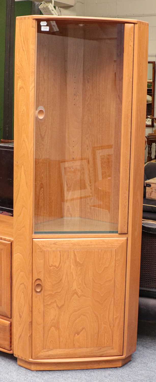 An Ercol Windsor style freestanding corner cupboard with glazed door, 72cm by 46cm by 196cm