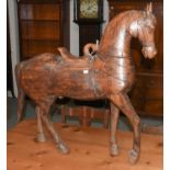 An early 20th century carved model of a horse in the Persian taste, 90cm by 94cm high