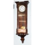 A 19th century rosewood Vienna type wall clock, housing an eight twin train movement, striking on