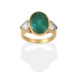 An Emerald and Diamond Three Stone Ring