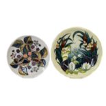 Four modern Moorcroft pottery plates comprising, Bullrush, Juneberry (second), Poppy (second), and